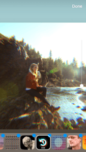 a girl wearing red jacket sitting on a cliff