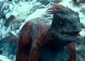 Red Dinosaur on a frozen lake that swims in cold water