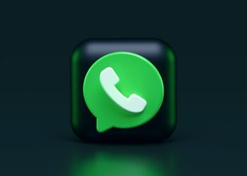A featured image of dark mode on WhatsApp showing a 3D render of WhatsApp logo/icon
