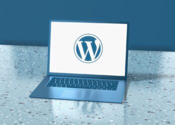 A laptop with WordPress logo placed on a surface