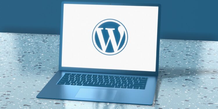 A laptop with WordPress logo placed on a surface