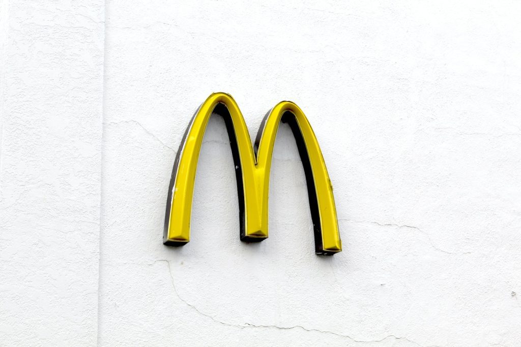 McDonalds logo in yellow with white background wall